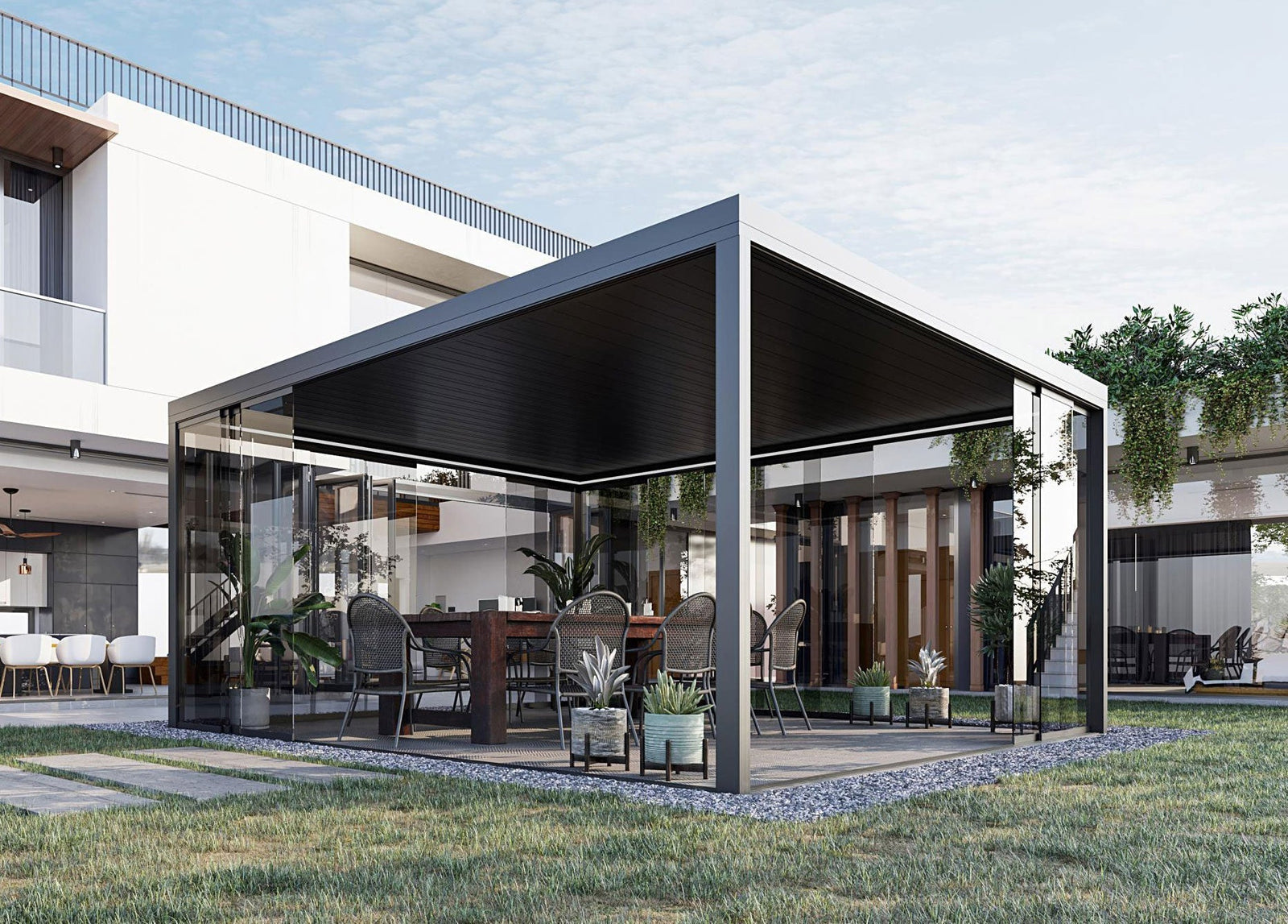 Modern glass-enclosed garden room with sleek black roof and outdoor dining setup