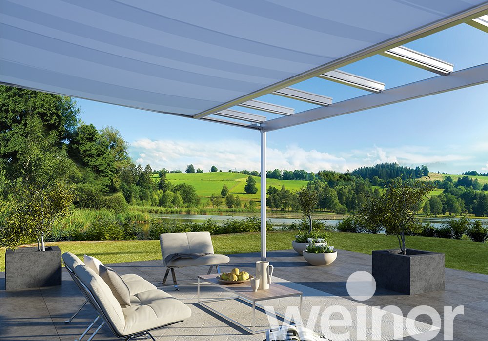 Modern outdoor pergola with retractable roof, patio furniture, and scenic garden view for luxury garden living