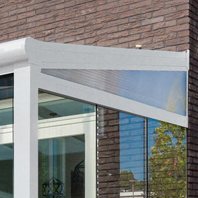 Modern patio veranda extension with clear side panel attached to brick house exterior