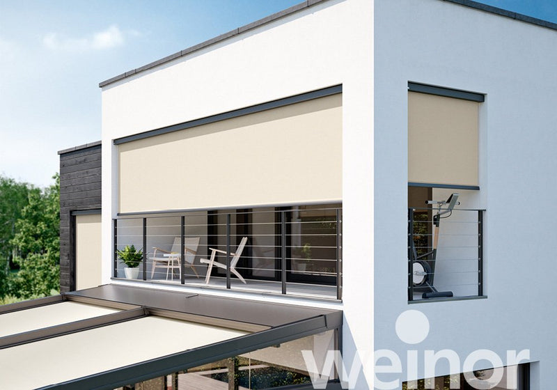 Modern balcony with beige roller shades and sleek metal railings for outdoor comfort