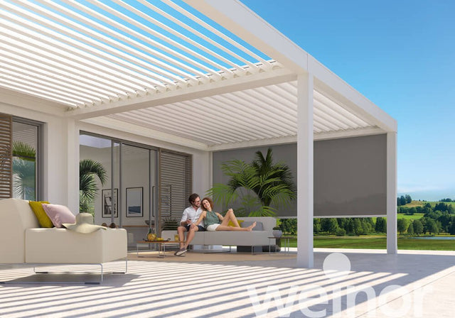 Modern white pergola on patio with outdoor seating, sunshade, and scenic garden view