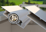 Close-up of aluminum pergola louver blade with visible gear mechanism outdoors