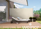 Modern garden patio with sun lounger, retractable awning, privacy screen, outdoor plants