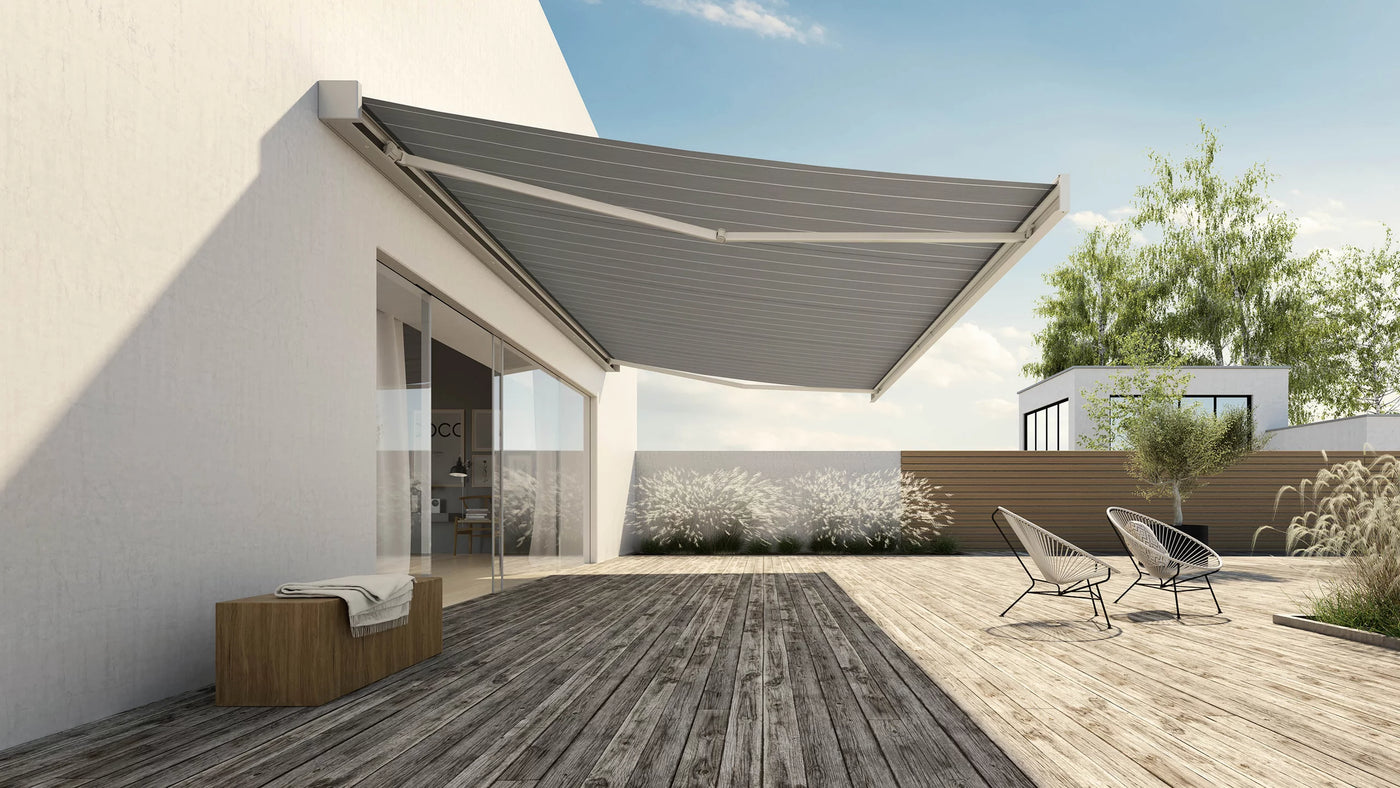 Modern retractable awning over wooden deck with outdoor chairs and garden view